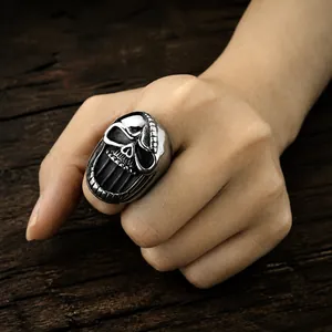 Detailed view of punk skull ring with intricate skeletal carvings on vintage background