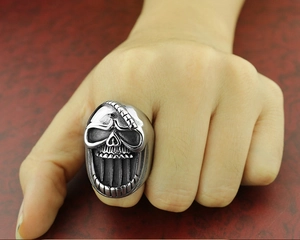 Macro shot of punk skull ring showing intricate vintage steel details and textured finish