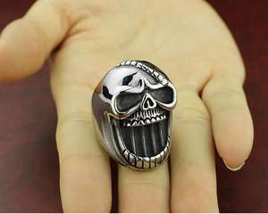 Detailed skull bottle opener ring in punk style, macro shot showcasing silver metal texture