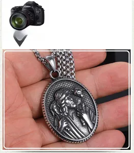 Detailed relief of a vintage stainless steel religious pendant with a Jesus shepherd motif