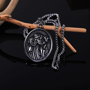 Vintage stainless steel necklace featuring a religious relief pendant with a square chain