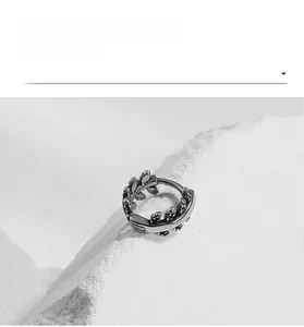 Detailed macro view of vintage stainless steel earring with leaf relief on stone