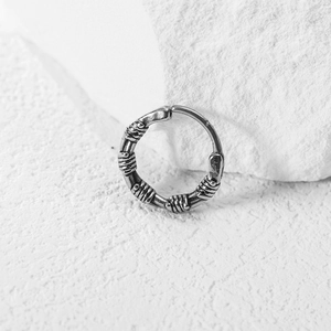 Vintage stainless steel hoop earring with intricate wire wrapping in retro hip-hop style