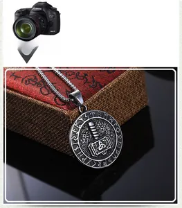 Macro shot of vintage Viking Mjölnir pendant with runes on a woven display box