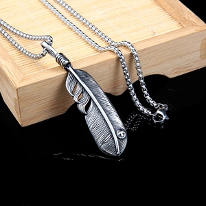 Vintage stainless steel feather pendant necklace with realistic texture on a pearl chain