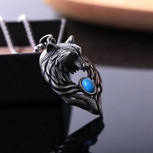 Collier avec pendentif tête de loup Viking et pierre bleue sur surface noire