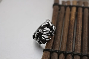 Macro shot of punk dragon claw ring in vintage silver finish with scale textures