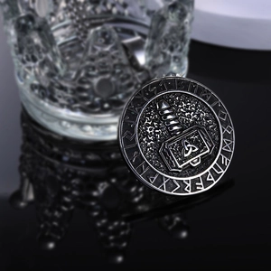 Macro shot of Viking Mjolnir pendant with Norse runes on vintage stainless steel
