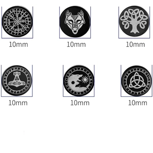Macro detail of 10mm black Viking rune stud earrings with silver Nordic totem engravings