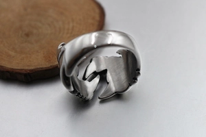 Macro detail of vintage punk dragon ring showing intricate interior relief and steel texture