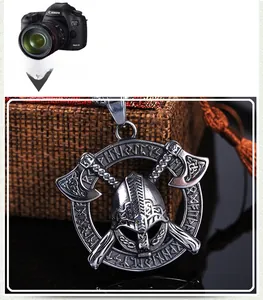 Close-up of vintage steel Viking warrior pendant with helmet, axes and Nordic rune details