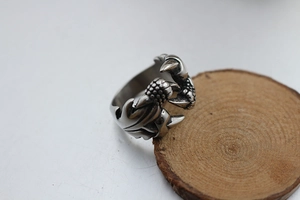 Macro detail of retro dragon claw ring in silver finish with realistic scale textures