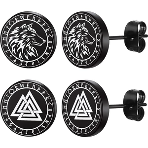Macro detail of black Viking stud earrings featuring silver wolf and Valknut runic symbols