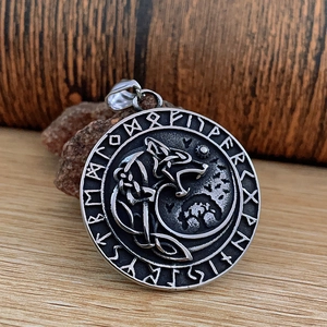 Nordic Viking wolf head pendant in vintage steel on natural stone and wood background