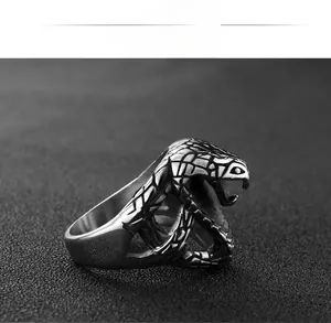 Macro detail of cobra head ring with vintage scales and black stainless steel finish
