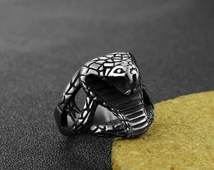 Detailed macro view of vintage stainless steel cobra snake ring with realistic scale texture