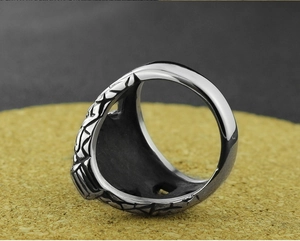Macro shot of punk style stainless steel snake ring with textured scale pattern