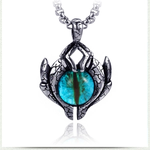 Macro shot of vintage evil eye pendant with blue iris and weathered silver flame texture