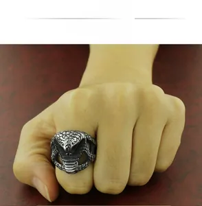 Close-up of a vintage stainless steel cobra snake ring with detailed scale textures