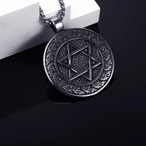 Macro shot of retro silver hexagram pendant with vintage relief on stainless steel chain