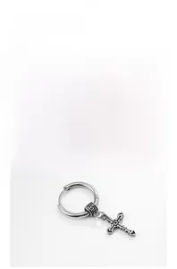 Close-up of vintage silver cross earring with detailed engraving on stainless steel