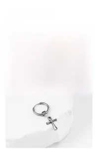 Close-up of vintage silver Ankh cross pendant earring on textured white stone background