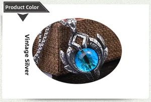 Macro shot of antique silver Evil Eye pendant with blue glass bead and flame texture