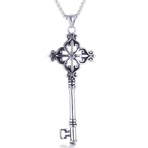 Macro shot of gothic stainless steel key pendant with vintage filigree details and chain