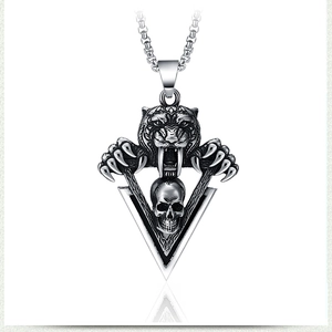Detailed view of gothic saber-toothed tiger and skull pendant in antique stainless steel