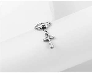 Macro view of silver stainless steel hoop earring featuring an Ankh cross pendant