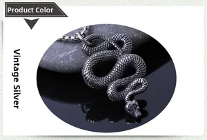 Close-up of vintage silver snake pendant with scale texture and square box chain