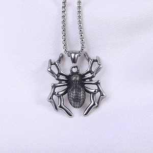Macro view of gothic spider pendant showing detailed metal texture and punk style legs