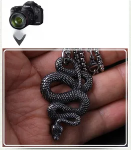 Macro shot of dark grey stainless steel snake pendant with detailed scales and ring chain