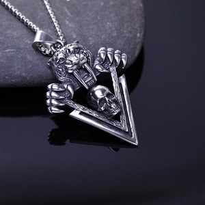 Macro view of a punk saber-tooth tiger skull pendant in vintage stainless steel finish
