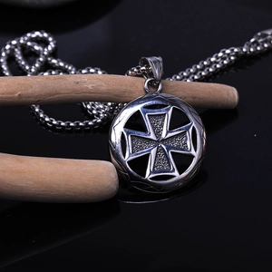 Retro stainless steel iron cross pendant with silver matte finish on black background