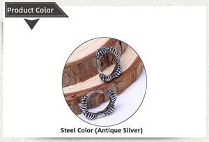 Detail view of retro antique silver hoop earrings with radial texture on wood background
