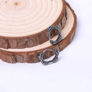 Retro silver metal hoop earrings with vintage engraved textures and industrial style