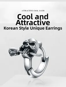 Close-up of retro silver skull and rose punk earrings with realistic metallic texture