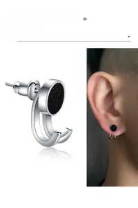 Macro shot of punk black stainless steel earring with starry texture and ear hook design