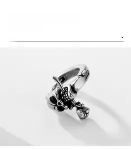 Detailed view of antiqued skull ring with rose flower design and vintage metal texture