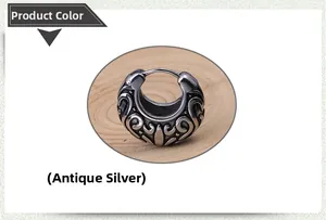 Detailed close-up of antique silver earrings with retro hollowed-out vine patterns