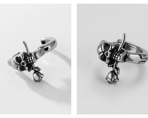 Detailed view of vintage silver skull and rose hoop earrings with gothic punk aesthetic