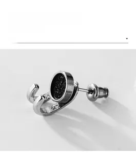 Macro side view of unisex black glitter stainless steel stud earring with butterfly back