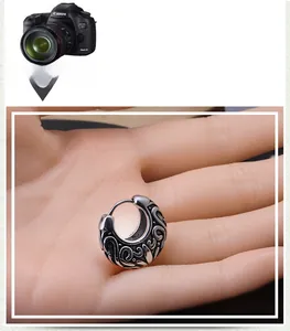 Detailed view of vintage silver earrings with engraved vine patterns and secure clasp
