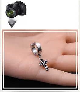 Macro shot of silver stainless steel gothic cross earrings with vintage dotted texture