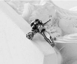 Macro side view of gothic skull biting rose ring with retro stainless steel finish