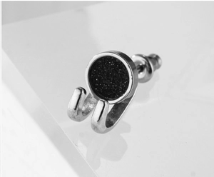 Macro view of punk style silver steel stud earring with black sand inlay and U-shape hooks