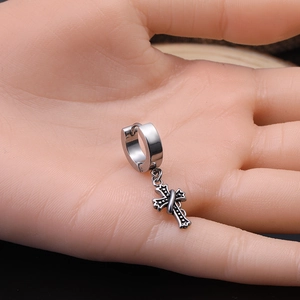 Gothic silver cross dangle earrings shown on hand to demonstrate actual size and fit