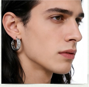 Detailansicht der Vintage-Titastahl-Creole mit graviertem geometrischem Muster auf einem Männermodel