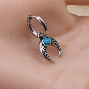 Boucle d'oreille homme en acier avec pendentif lune turquoise présentée sur la main